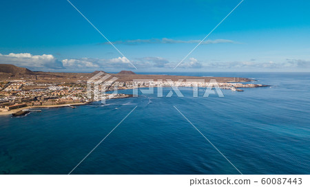 aerial view of waves crashing on the bay of corralejo, fuerteventura aerial view of waves crashing on the bay of corralejo, fuerteventura 60087443