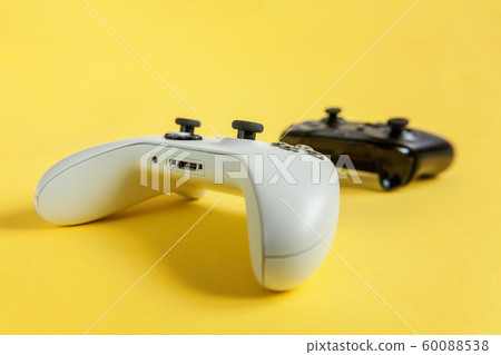 White and black two joystick on yellow background. White and black two joystick on yellow background. 60088538