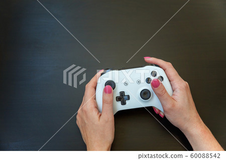 Woman hand holding white joystick isolated on 60088542
