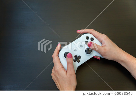 Woman hand holding white joystick isolated on Woman hand holding white joystick isolated on 60088543