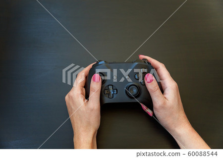 Woman hand holding black joystick isolated on Woman hand holding black joystick isolated on 60088544