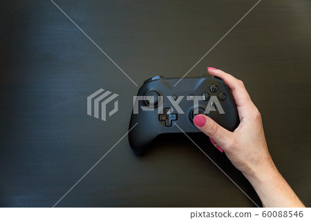 Woman hand holding black joystick isolated on Woman hand holding black joystick isolated on 60088546