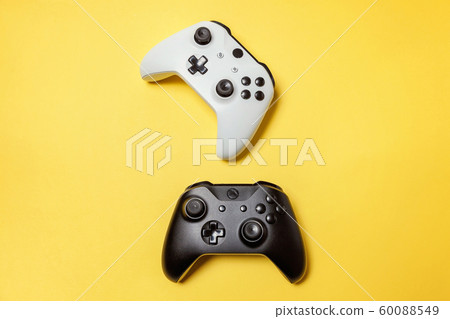 White and black two joystick on yellow background. White and black two joystick on yellow background. 60088549