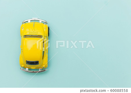 Yellow vintage retro toy car isolated on blue 60088558