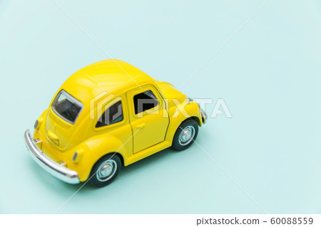 Yellow vintage retro toy car isolated on blue 60088559