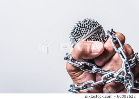 Hand holding microphone and have chain on fist hand on white background Hand holding microphone and have chain on fist hand on white background 60092628