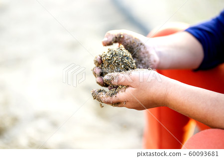 Child making dumplings with sand and copy space Child making dumplings with sand and copy space 60093681