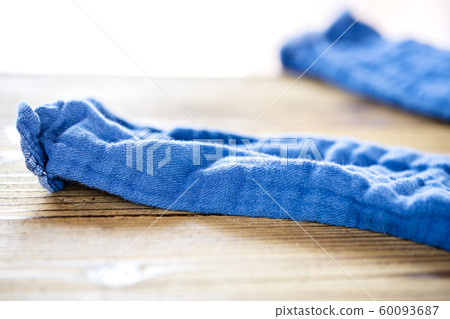 Blue pants stripped off on a wooden table 60093687