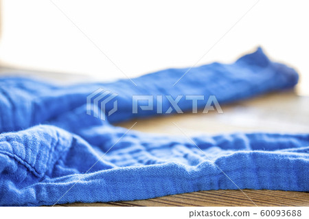Undressed blue pants on a wooden table 60093688