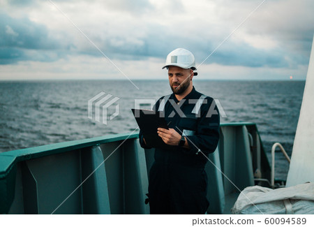 Deck Officer on deck of offshore vessel or ship , wearing PPE personal protective equipment Deck Officer on deck of offshore vessel or ship , wearing PPE personal protective equipment 60094589
