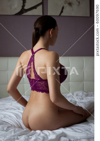 Woman in purple bra in bedroom 60097690