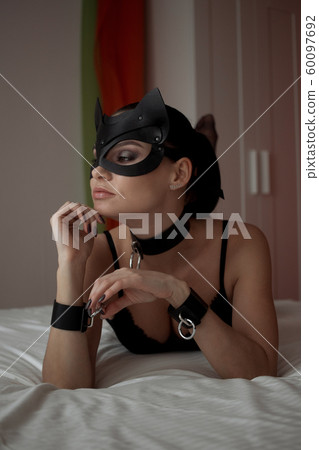 Brunette girl in a cat mask Brunette girl in a cat mask 60097692