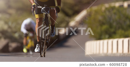 Cycling competition,cyclist athletes riding a race,climbing up a hill on a bicycle 60098728