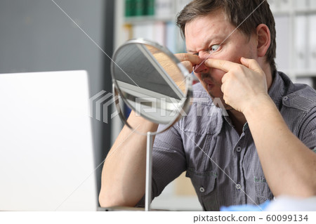 man sits in front of a mirror and crushes acne man sits in front of a mirror and crushes acne 60099134