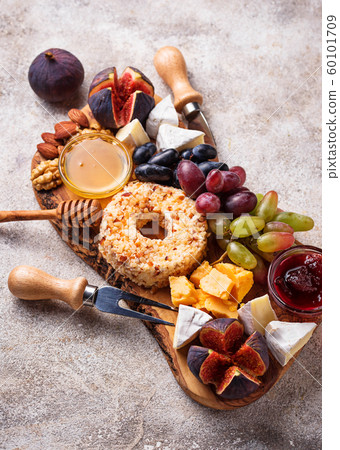 Appetizer for wine, cheese plate with grapes and figs Appetizer for wine, cheese plate with grapes and figs 60101709