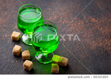 Glasses of absinthe with brown sugar 60101805