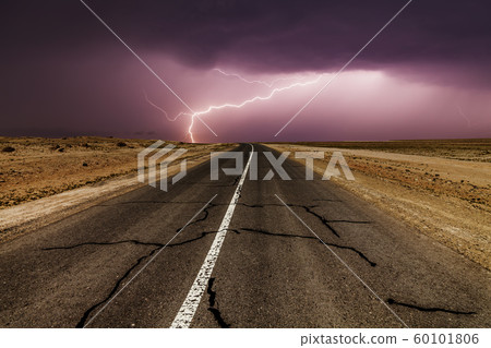 Stormy country road at night, with intense lightning strikes. Stormy country road at night, with intense lightning strikes. 60101806