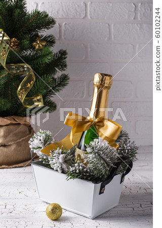 Bottle of champagne in a gold wrapper 60102244