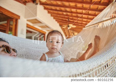 Baby girl sit in hammock Baby girl sit in hammock 60102256