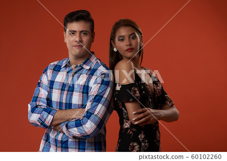 Young man and woman with crossed arms Young man and woman with crossed arms 60102260