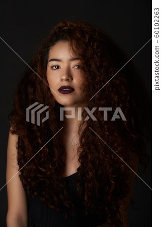 Young hispanic woman with fluffy hair Young hispanic woman with fluffy hair 60102263