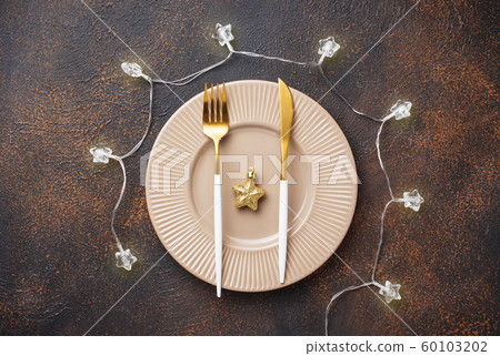 Christmas table setting and golden decor Christmas table setting and golden decor 60103202