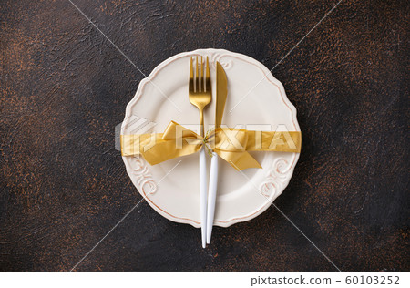 Christmas table setting and golden decor 60103252