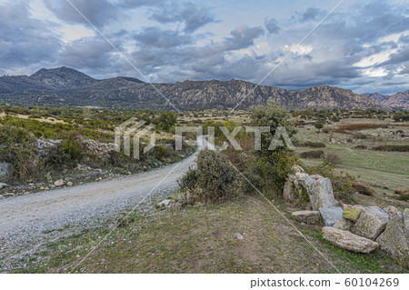 landscape with rural road and in the background landscape with rural road and in the background 60104269