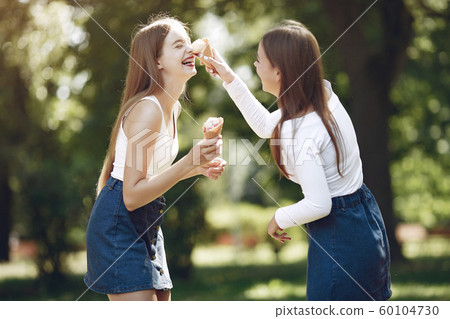 Two elegant and stylish girls in a spring park 60104730