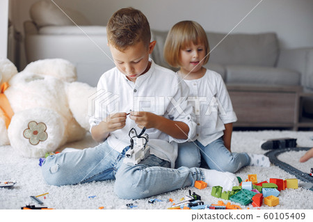 Children playing with lego in a playing room Children playing with lego in a playing room 60105409