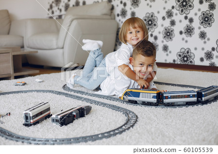 Children playing with lego and toy train in a playing room 60105539
