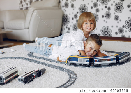 Children playing with lego and toy train in a playing room Children playing with lego and toy train in a playing room 60105566