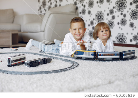 Children playing with lego and toy train in a playing room 60105639