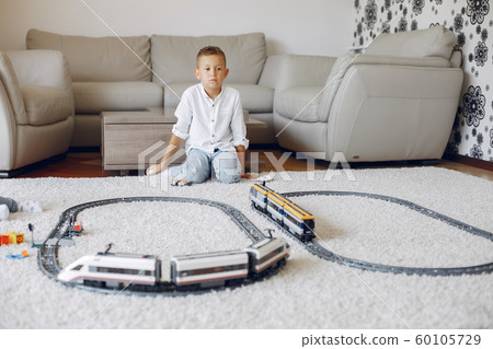 Child playing with toy train in a playing room 60105729