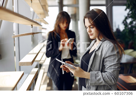 Two businesswomen working in a cafe Two businesswomen working in a cafe 60107306