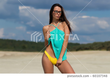 Seductive female on sunny day on beach Seductive female on sunny day on beach 60107348