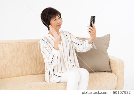 Senior woman smartphone video call Senior woman smartphone video call 60107922