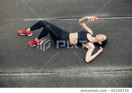 Sports girl training at the stadium Sports girl training at the stadium 60108356