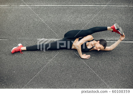 Sports girl training at the stadium Sports girl training at the stadium 60108359