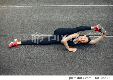 Sports girl training at the stadium Sports girl training at the stadium 60108372