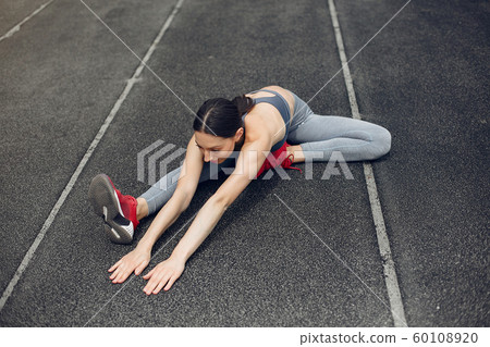 Sports girl training at the stadium Sports girl training at the stadium 60108920