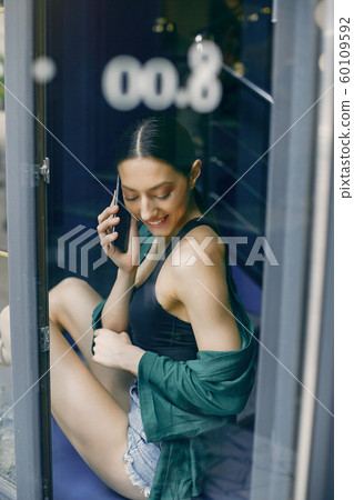 Fashion girl standing in a summer cafe Fashion girl standing in a summer cafe 60109592