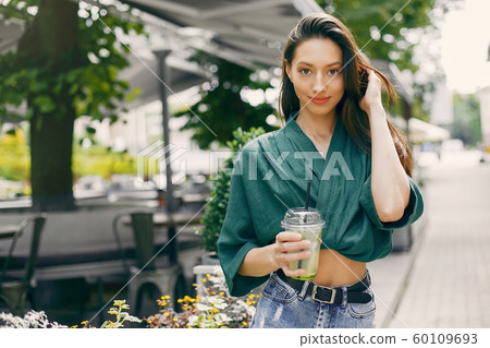 Fashion girl standing in a summer city 60109693