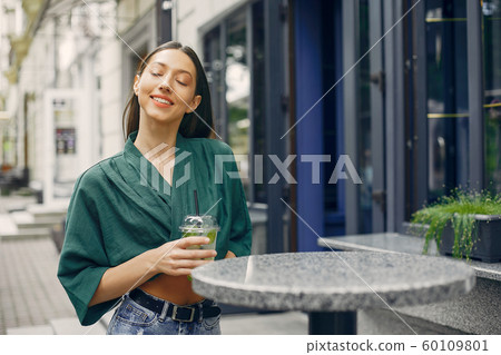 Fashion girl standing in a summer city Fashion girl standing in a summer city 60109801