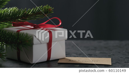 merry christmas paper card next to gift box merry christmas paper card next to gift box 60110149