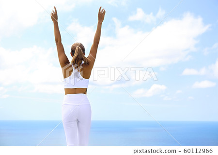 Beautiful woman making stretching exercises in the 60112966