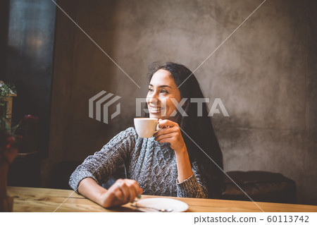 beautiful woman drinking coffee in a cafe beautiful woman drinking coffee in a cafe 60113742