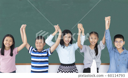 Group of young diversity Asian children and teacher smiling rising hands show glory in classroom.  60114793