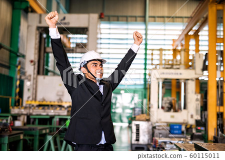 Happy businessman celebrate in factory 60115011