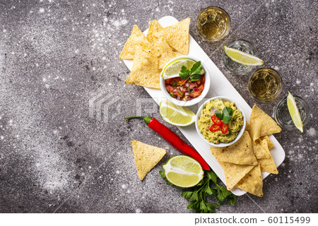 Guacamole, salsa, chips nachos and tequila Guacamole, salsa, chips nachos and tequila 60115499